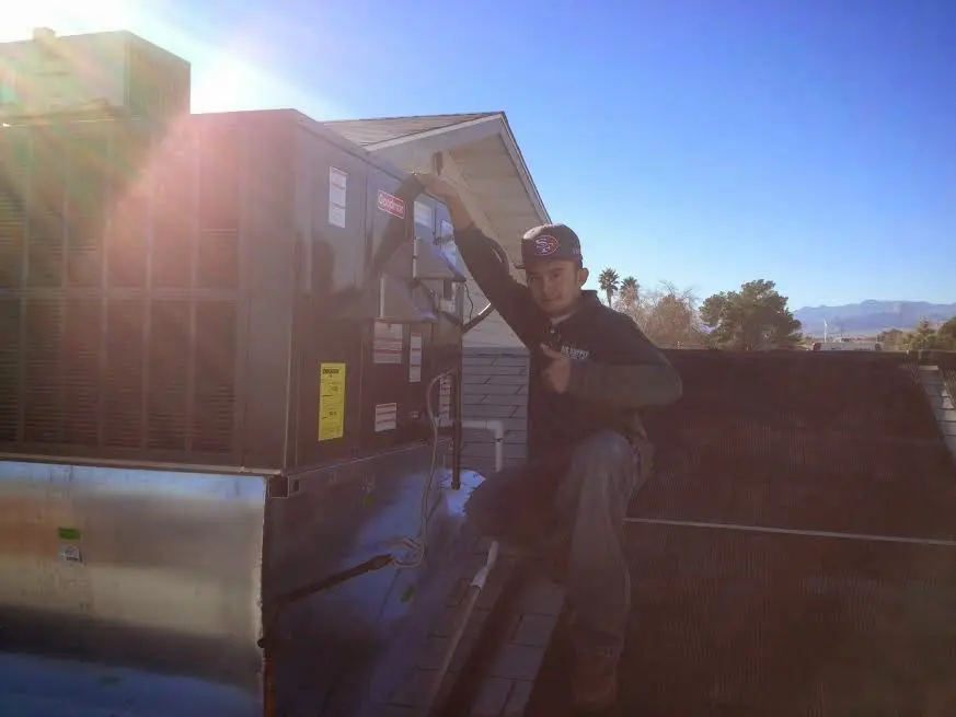HVAC technician performing Boiler Repair on a rooftop unit in Coraopolis